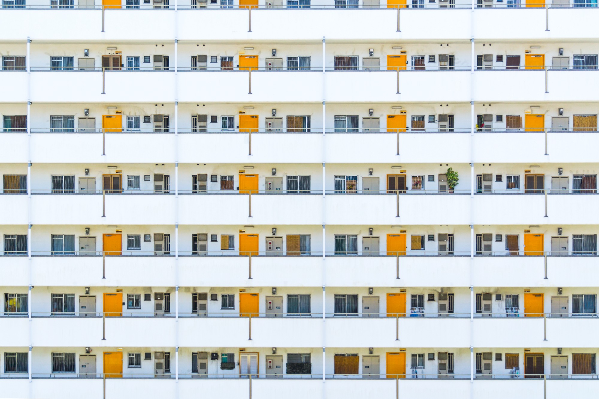 “The symmetrical apartment units with orange doors in Osaka“ by Tim Easley on Unsplash