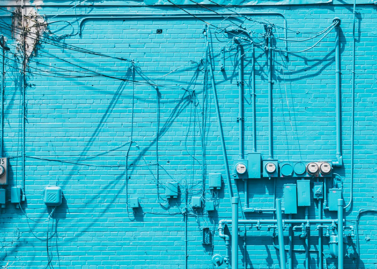 Blue wall with chaos of wires